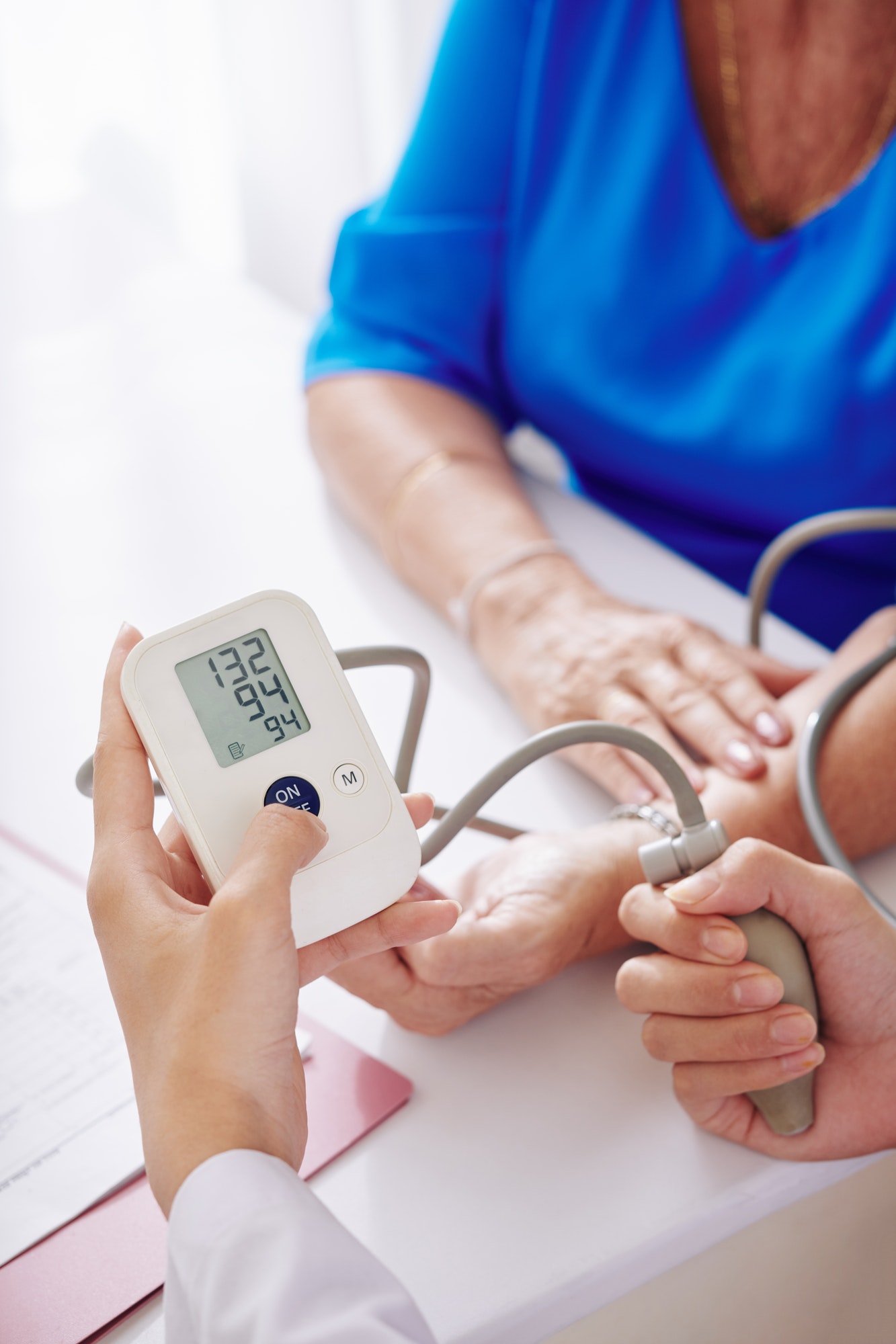 General practitioner checking blood pressure